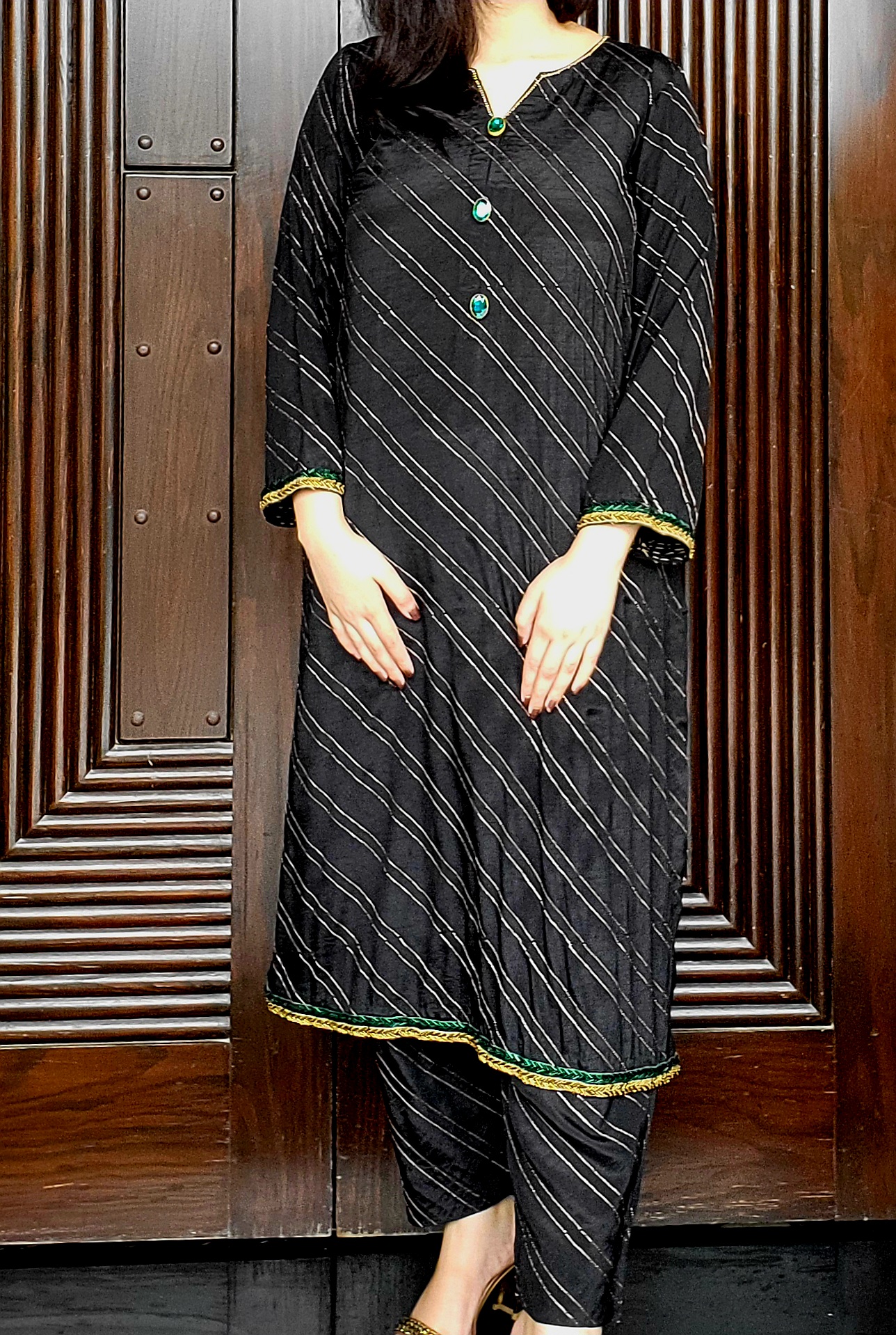 2 piece black grip fabric outfit with golden tari lines, short shirt and embroidered trouser – available in small size only at Amqara